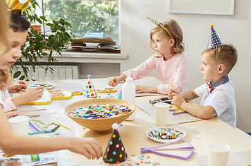 Image showing Girl birthday decorations. table setting with cakes, drinks and party gadgets.