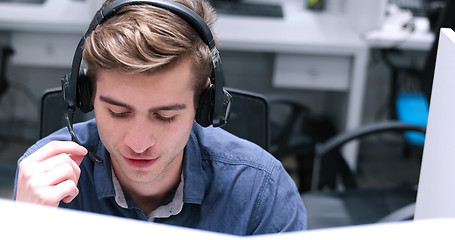 Image showing male call centre operator doing his job