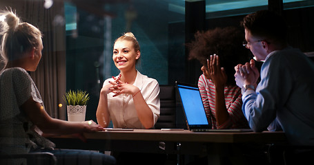 Image showing Multiethnic startup business team in night office