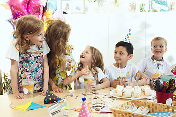 Image showing Girl birthday decorations. table setting with cakes, drinks and party gadgets.