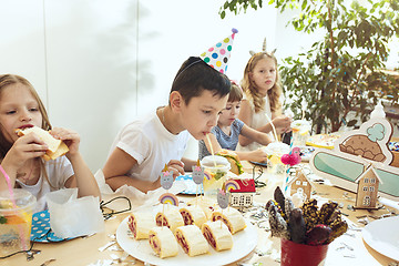 Image showing Girl birthday decorations. table setting with cakes, drinks and party gadgets.