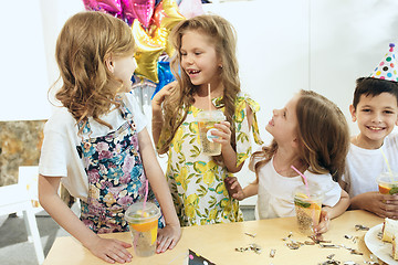 Image showing Girl birthday decorations. table setting with cakes, drinks and party gadgets.