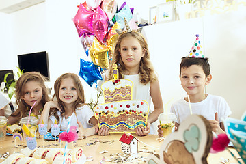 Image showing Girl birthday decorations. table setting with cakes, drinks and party gadgets.