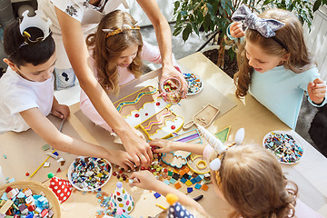 Image showing Girl birthday decorations. table setting with cakes, drinks and party gadgets.