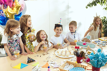 Image showing Girl birthday decorations. table setting with cakes, drinks and party gadgets.