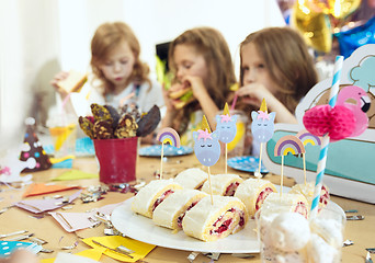 Image showing Girl birthday decorations. table setting with cakes, drinks and party gadgets.