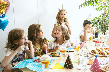 Image showing Girl birthday decorations. table setting with cakes, drinks and party gadgets.