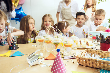 Image showing Girl birthday decorations. table setting with cakes, drinks and party gadgets.