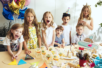 Image showing Girl birthday decorations. table setting with cakes, drinks and party gadgets.