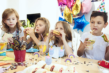 Image showing Girl birthday decorations. table setting with cakes, drinks and party gadgets.