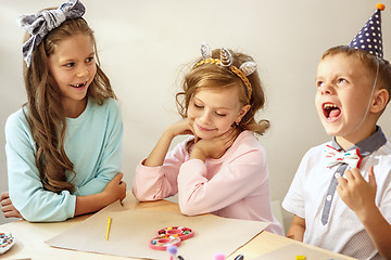 Image showing Girl birthday decorations. table setting with cakes, drinks and party gadgets.