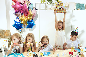 Image showing Girl birthday decorations. table setting with cakes, drinks and party gadgets.