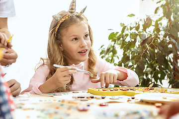 Image showing mosaic puzzle art for kids, children\'s creative game. two sisters are playing mosaic