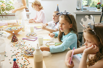 Image showing Girl birthday decorations. table setting with cakes, drinks and party gadgets.