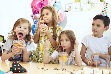 Image showing Girl birthday decorations. table setting with cakes, drinks and party gadgets.