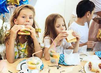 Image showing Girl birthday decorations. table setting with cakes, drinks and party gadgets.