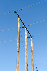 Image showing Electricity transmission cables by wooden poles