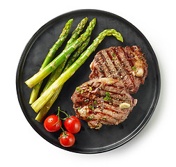 Image showing plate of grilled steaks on white background