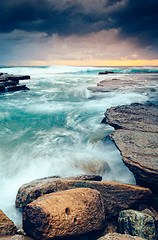 Image showing Storm clouds and moody oceans as mosrning breaks on the horizon