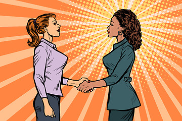 Image showing African and Caucasian businesswomen shaking hands