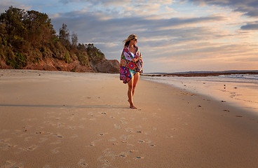 Image showing Female relaxed morning walks along the beach