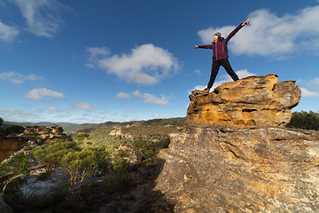 Image showing Female hiker on top of a pagodas after climbing up with views