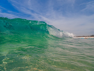 Image showing Ocean beach wave curling  onto the shore