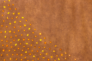 Image showing Shiny amber gems on textured leather background