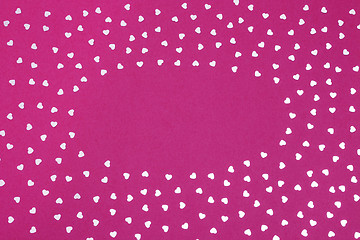 Image showing Frame made of glitter hearts on purple background