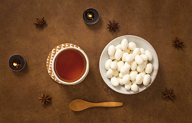 Image showing Tea and almonds in white chocolate