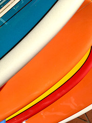 Image showing Colourful surfboards lined up in a row