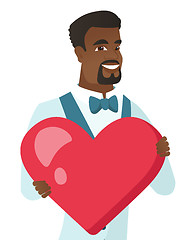 Image showing Young african-american groom holding a big heart.