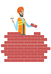 Image showing Hindu bricklayer working with spatula and brick.