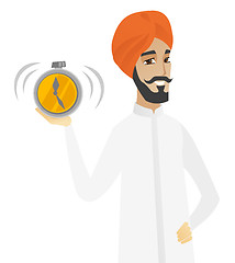 Image showing Hindu businessman holding alarm clock.