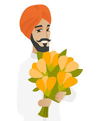 Image showing Hindu businessman holding bouquet of flowers.