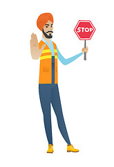 Image showing Young hindu builder holding stop road sign.