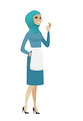 Image showing Young muslim cleaner showing ok sign.