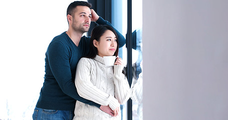 Image showing multiethnic couple relaxing at modern home indoors