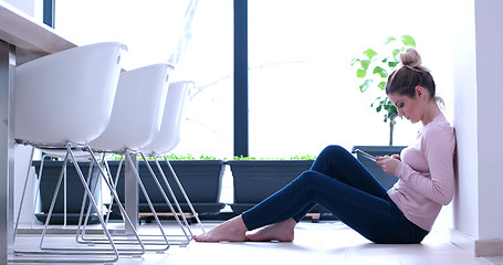 Image showing young women using tablet computer on the floor