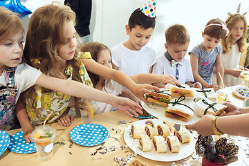 Image showing Girl birthday decorations. table setting with cakes, drinks and party gadgets.