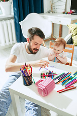 Image showing father and his baby daughter at home