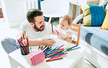 Image showing father and his baby daughter at home