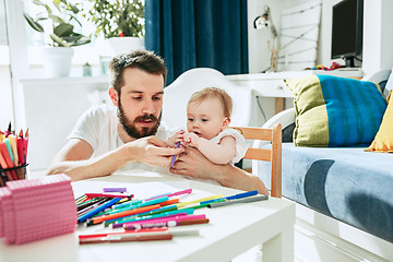 Image showing father and his baby daughter at home