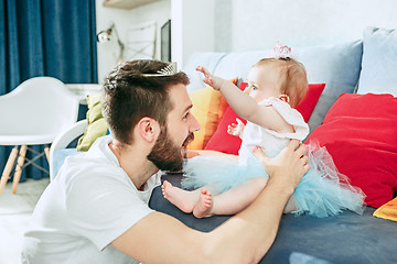 Image showing Proud father holding his baby daughter at home