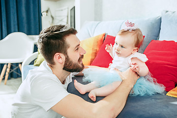 Image showing Proud father holding his baby daughter at home