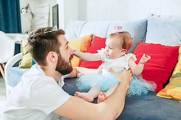 Image showing Proud father holding his baby daughter at home