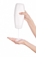 Image showing White bottle of shower gel lotion cream in hands