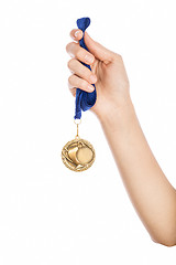 Image showing Girl hand raised holding gold medal 