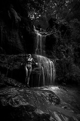 Image showing Bikini woman stands in remote bushland waterfall