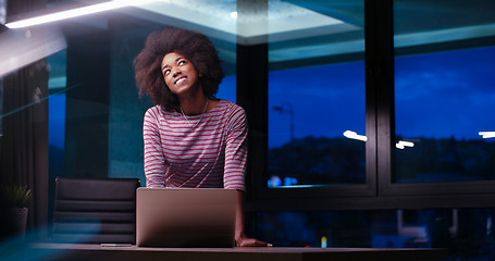 Image showing black businesswoman using a laptop in night startup office